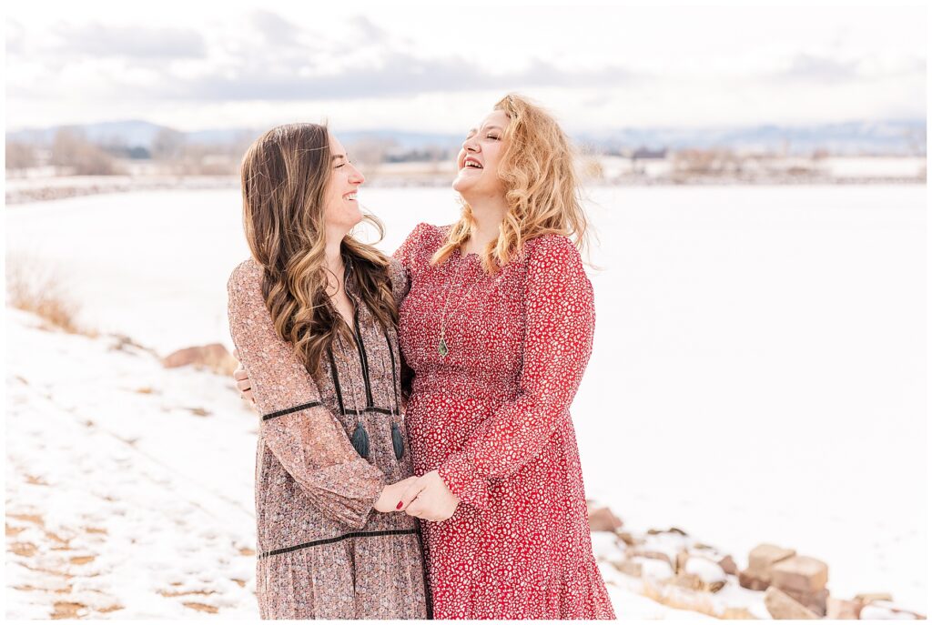 Ladies hold hands and laugh together during photos with Catherine Chamberlain Photography