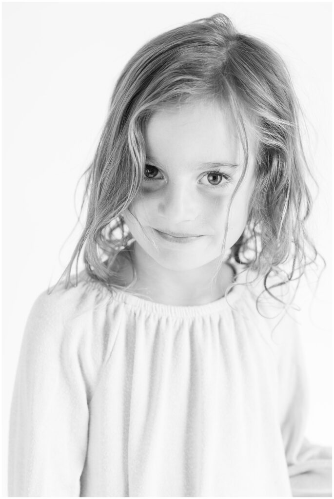 Little girl smiles sweetly showing her kind personality during mini sessions at Sugarhill Studio