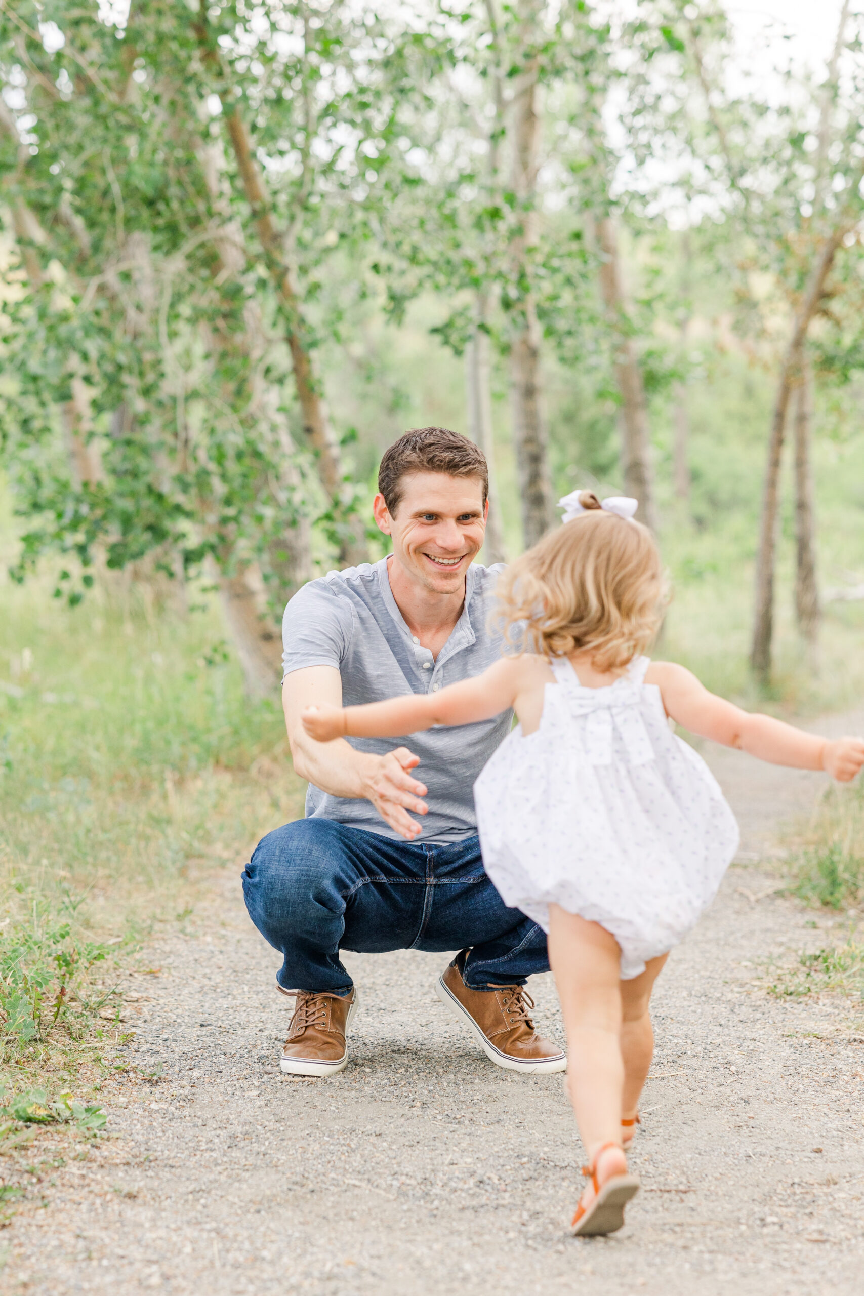 Little girl running to her dad for how to prepare kids for photoshoots by Catherine Chamberlain Photography