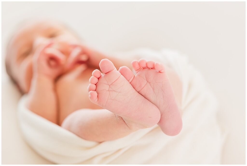 Up-close shot of newborn's feet and toes using newborn session preparation tips by Catherine Chamberlain Photography
