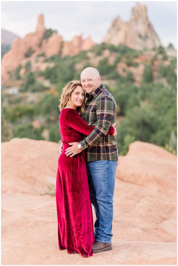 Portrait shot of couple embracing on a red rock formation at Garden of the Gods in Colorado Springs, CO