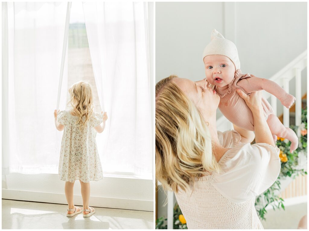 Little girl opens the curtains and looks out the window during Mother's Day mini session