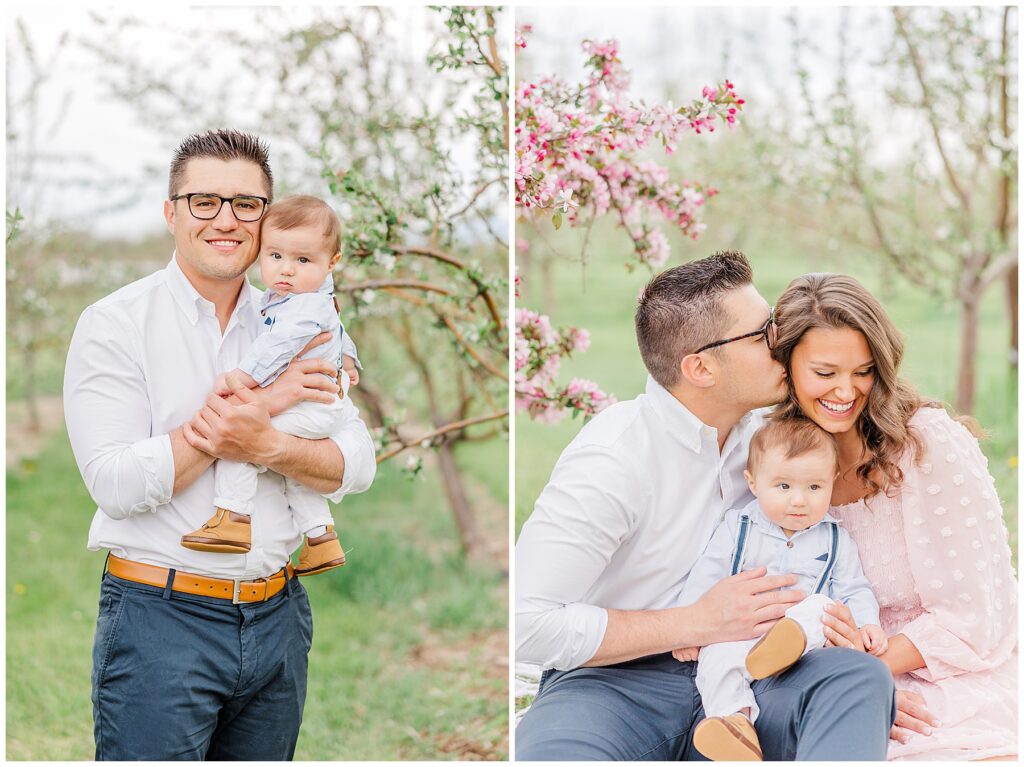 Husband kisses his wife as she holds their baby boy while squatting during outdoor spring mini sessions