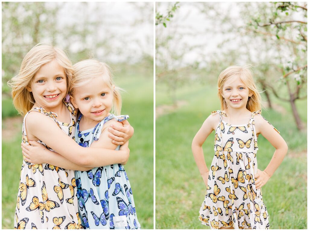 Older sister poses in an orchard with her hands on her hips during outdoor spring mini sessions