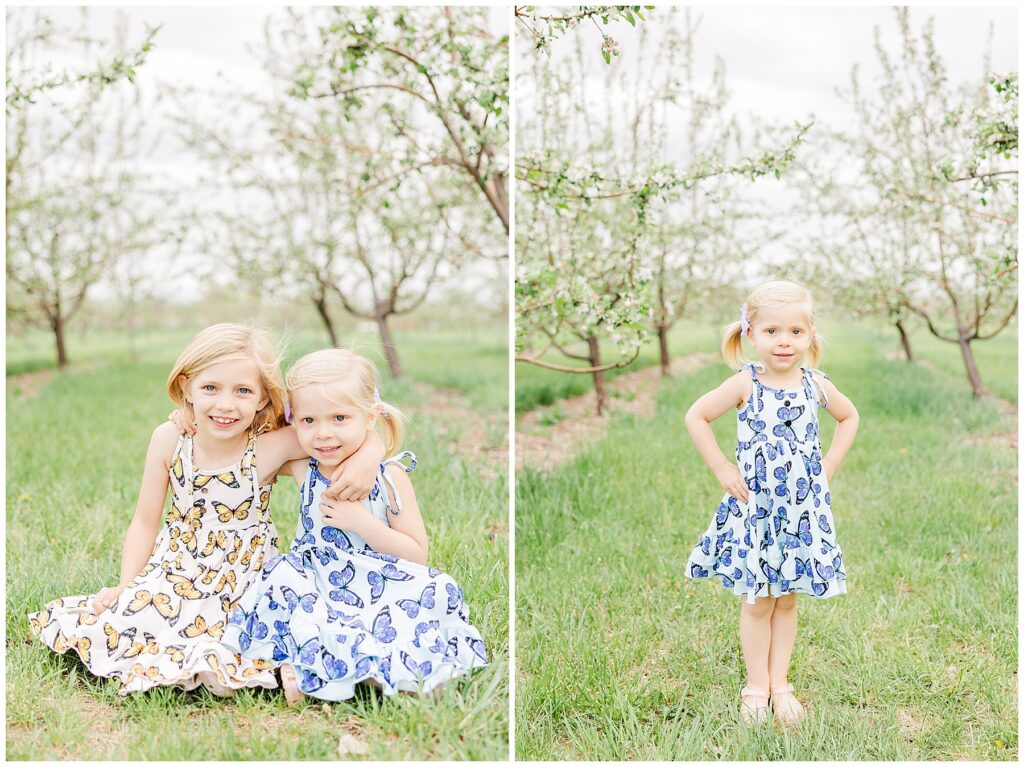 Sisters sit on the ground with their arms around each other's necks during outdoor spring mini sessions
