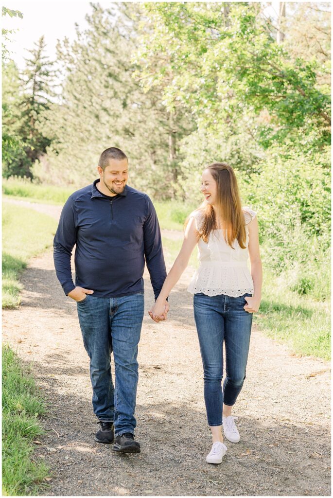 Husband and wife walk hand in hand down a path at Fly’n B Park in Highlands Ranch, CO during the O’Toole Outdoor Family Session