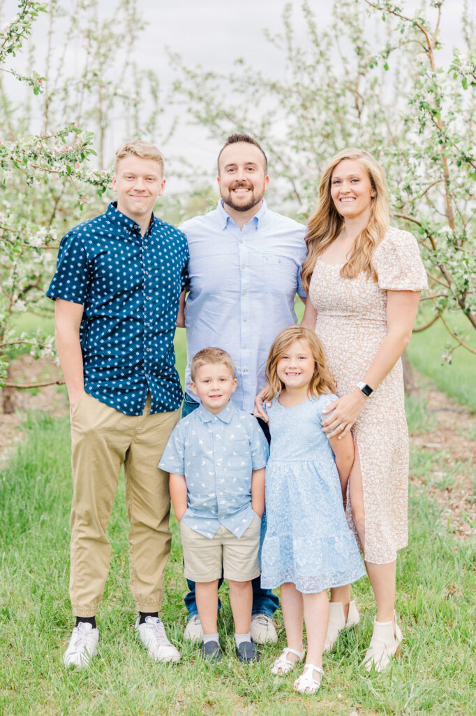 Family of five stand together at Ya Ya Orchard in Longmont, CO