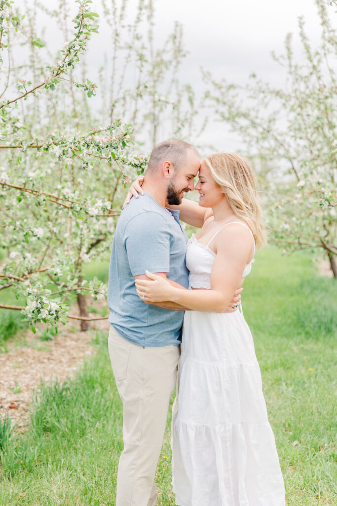 Couple does intimate pose hugging closely in beautiful Ya Ya orchard with Catherine Chamberlain Photography