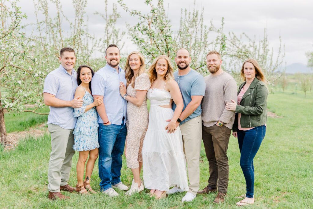 Siblings and their significant others stand and pose during Lantzy Extended Family Session at Ya Ya Orchard in Longmont, CO