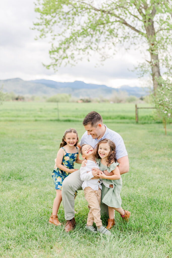Dad gets his kids laughing and giggling during a family photoshoot with Catherine Chamberlain Photography