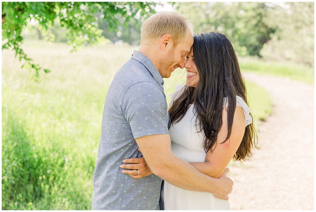 Husband and wife stand with their foreheads pressed together and holding each other for South Denver Mini Session 