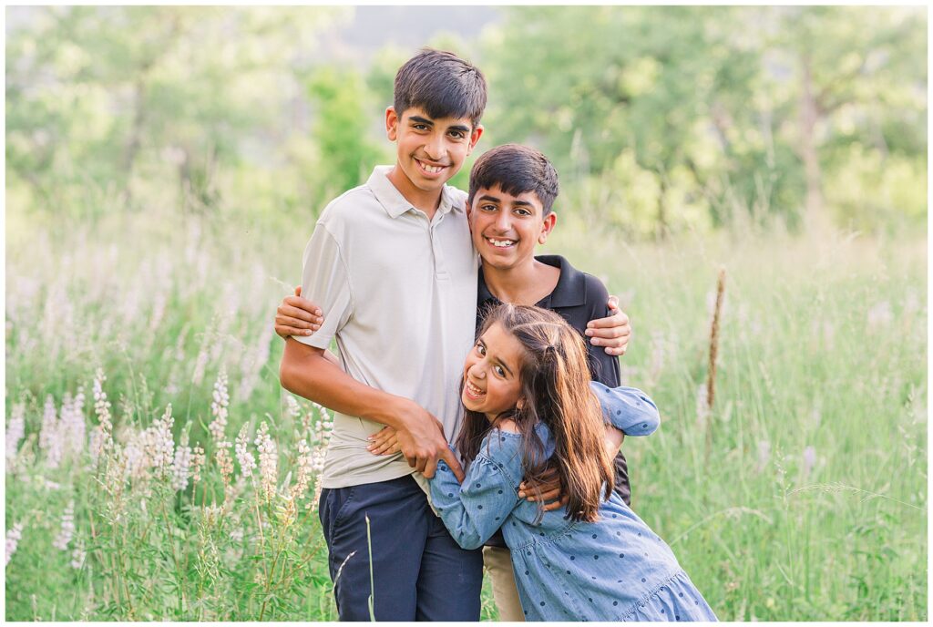 Siblings group hug for Mehra Outdoor Family Session at South Mesa Trailhead in Boulder, CO