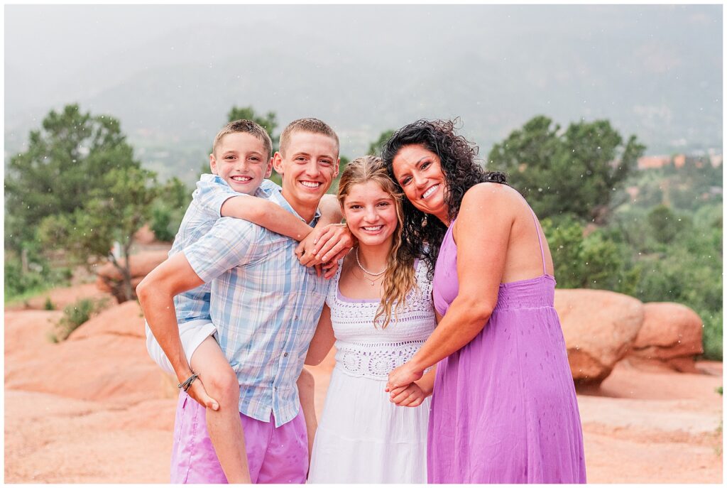 Family of four pose for light and airy photos at Garden of the Gods with Catherine Chamberlain Photography based in Northern Colorado