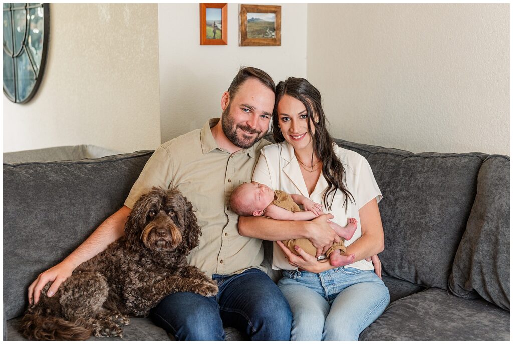 Couple pose with their newborn and dog for this in-home Colorado newborn session