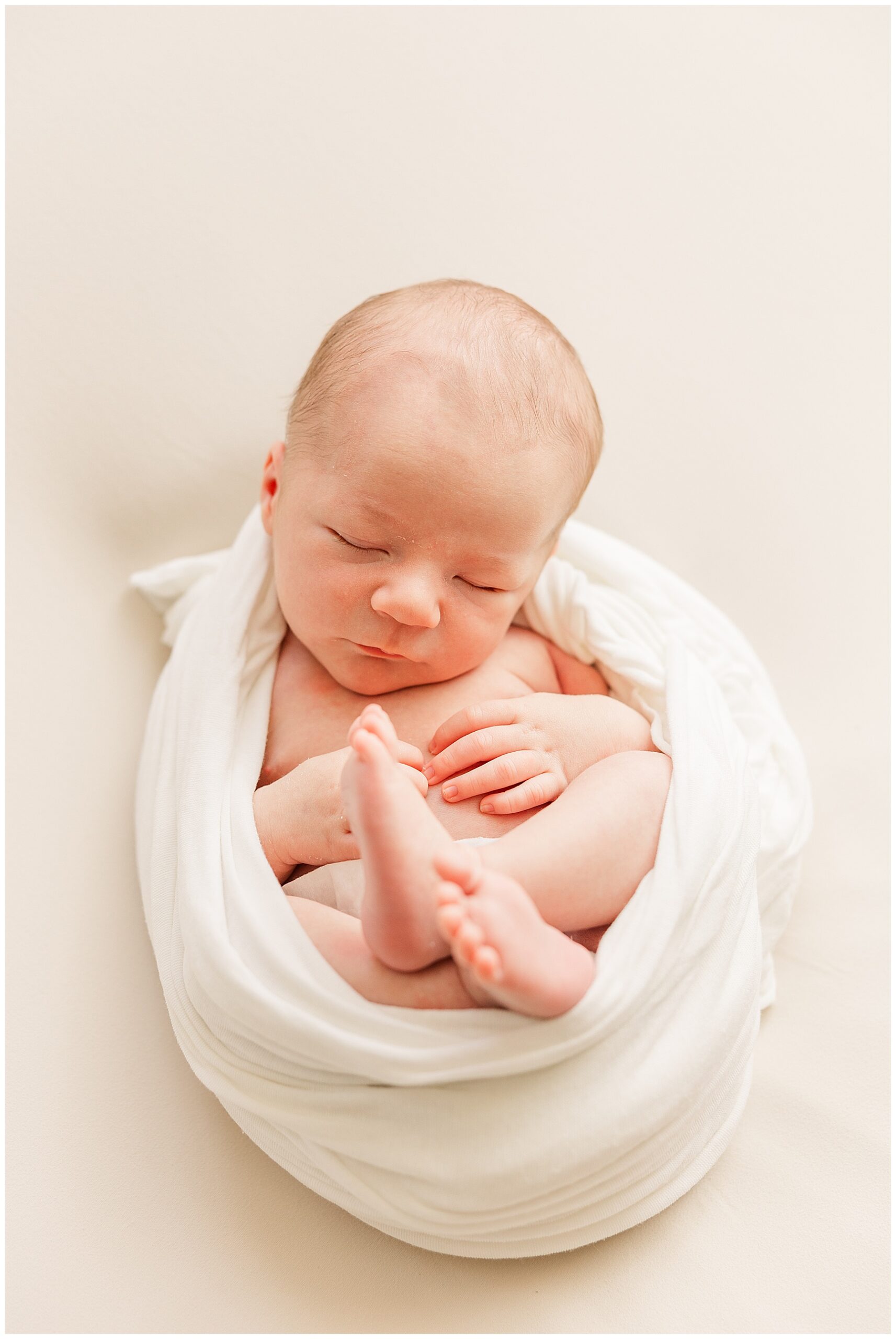 Baby boy sleeps soundly while swaddled for this in-home Colorado newborn session with Catherine Chamberlain Photography