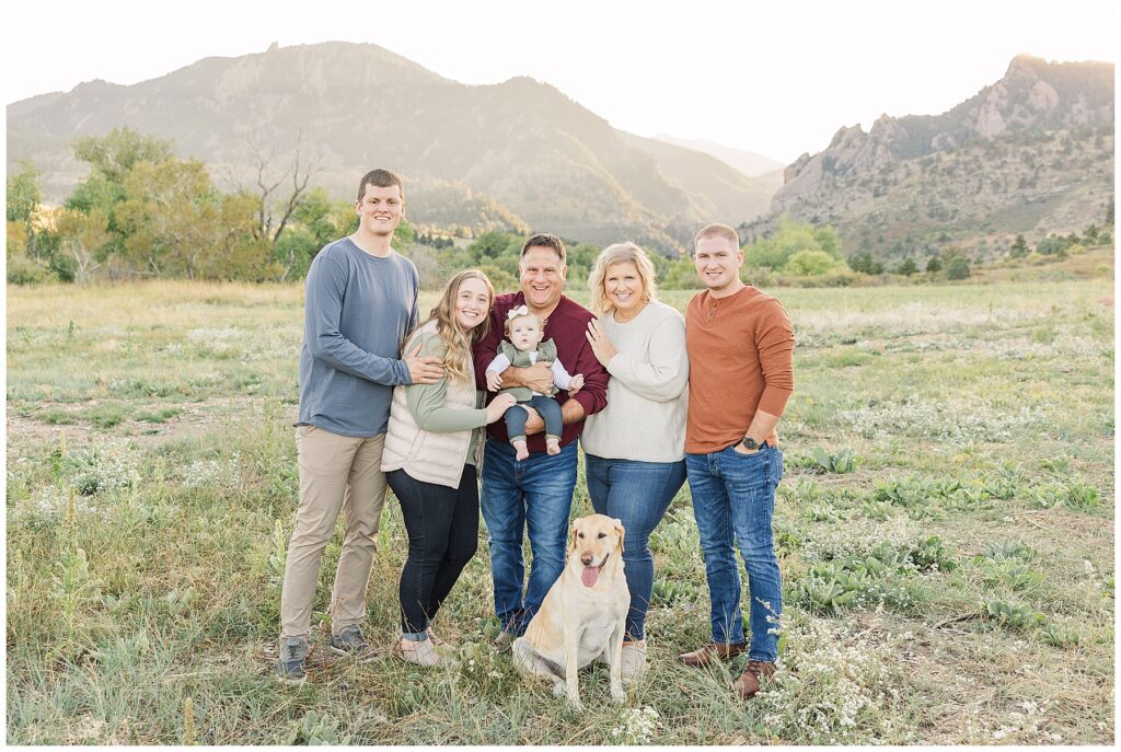 Extended family pose with their white lab dog for outdoor photos at South Mesa Trailhead in Boulder, CO