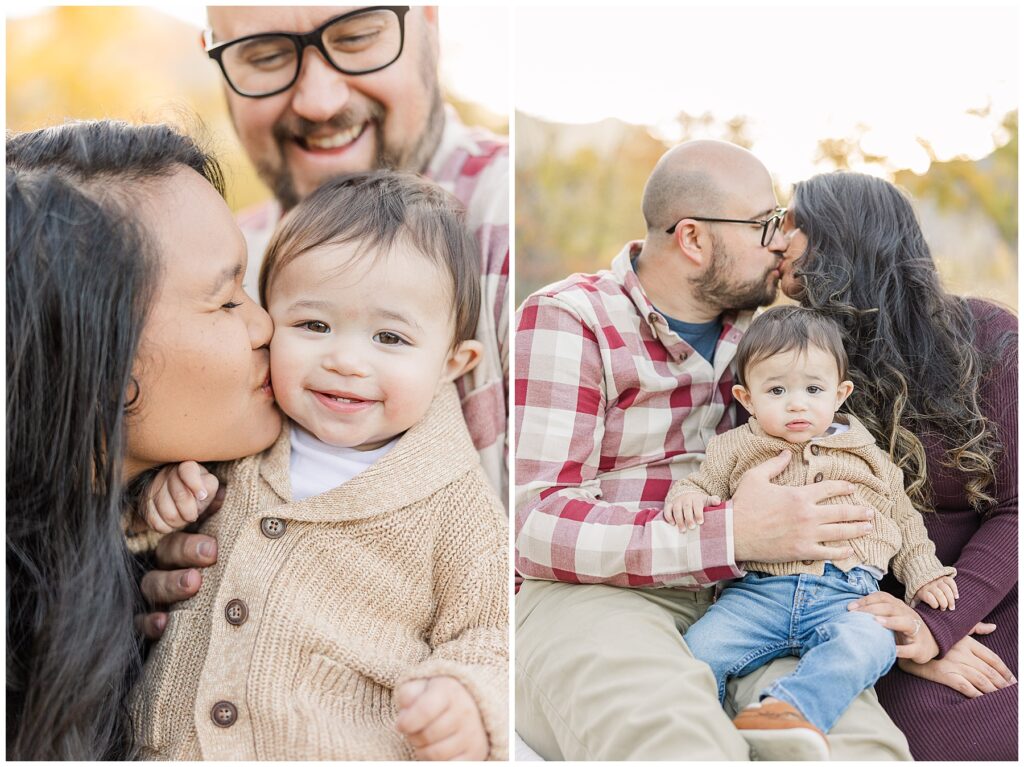 Mom and dad kiss while holding their toddler boy on their lap for family photographer Catherine Chamberlain 