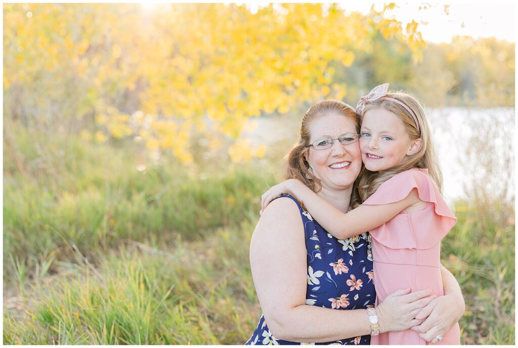 Mom and daughter snuggle cheek to cheek for outdoor photos with Catherine Chamberlain Photography