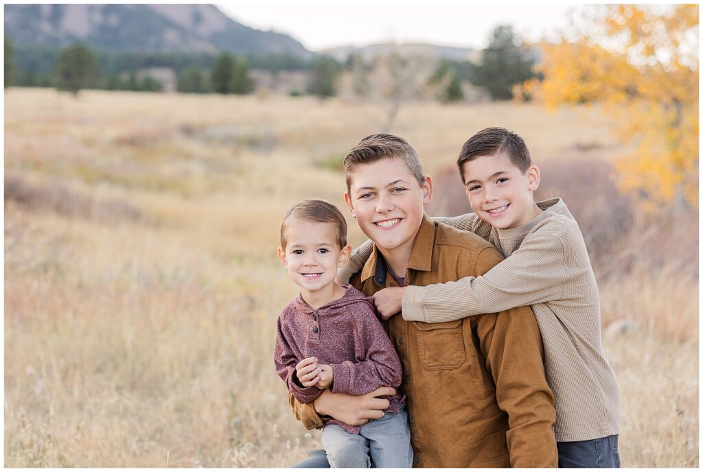 Three brothers sit together for light and airy family photos by Catherine Chamberlain Photography