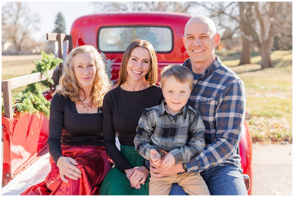 Family of four pose for outdoor truck Christmas Minis in Louisville, CO