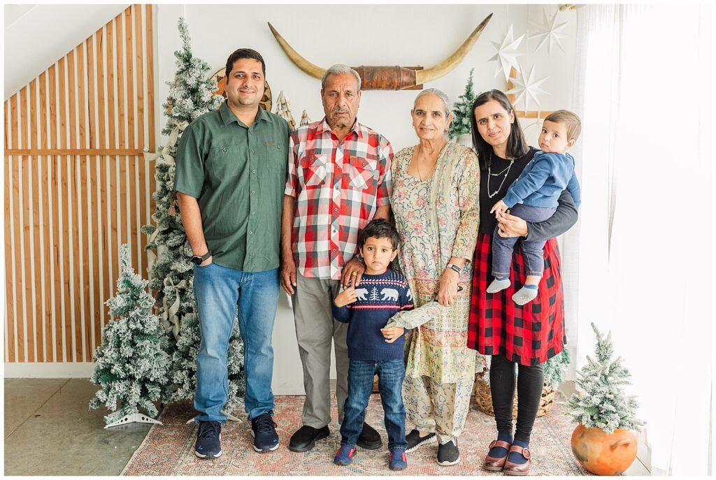 Extended family stand in front of a Southwest themed Christmas studio family mini session