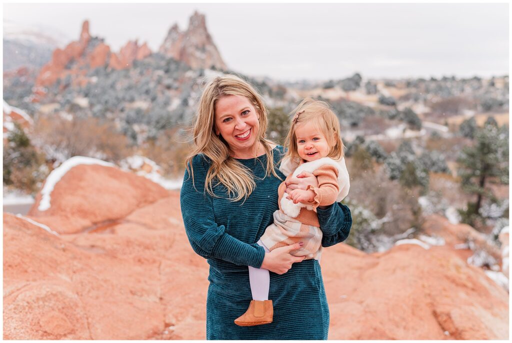 Mother holds her toddler for snowy outdoor family minis with Catherine Chamberlain Photography