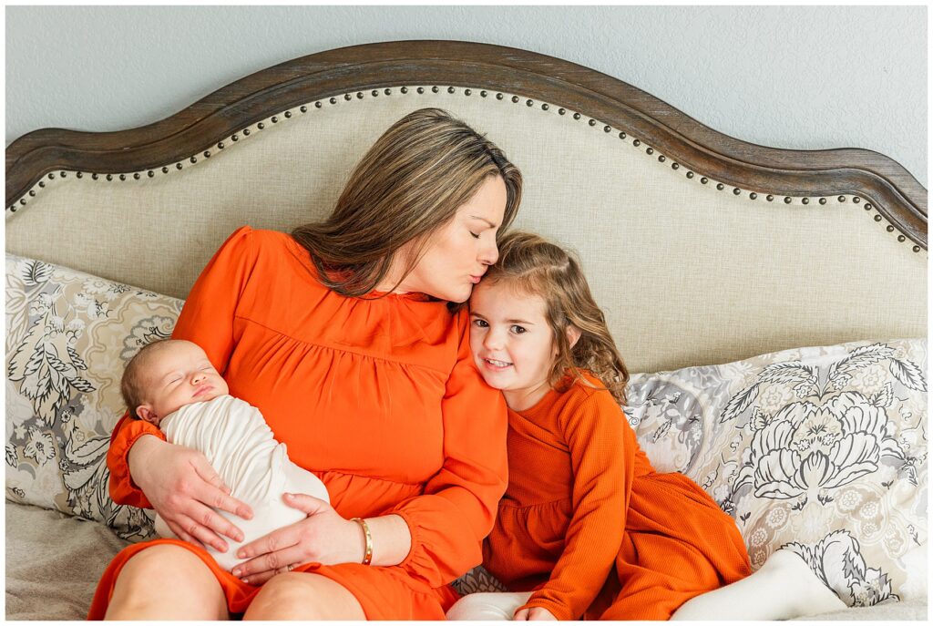 Mom poses with her daughter and newborn girl with Catherine Chamberlain Photography