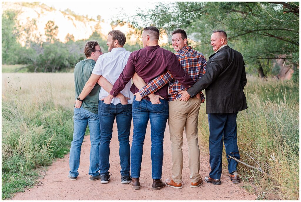Extended family funny pose with hands in each other's back pockets in Northern Colorado