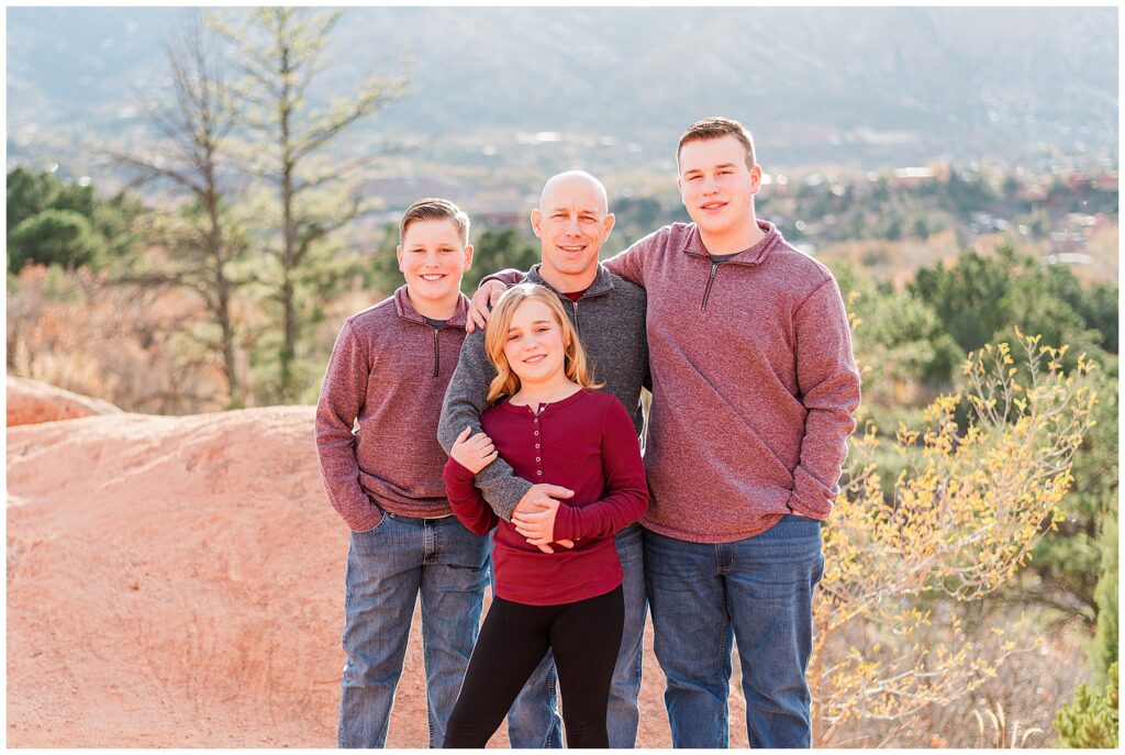 Dad poses with his three kids for light and airy family pictures by Catherine Chamberlain of Longmont, Colorado