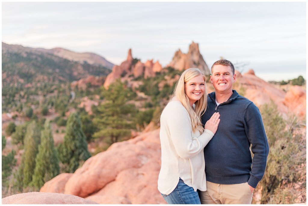 Couple pose as the wife places her hand on her husband's chest during Colorado Springs Family Sessions at Garden of the Gods