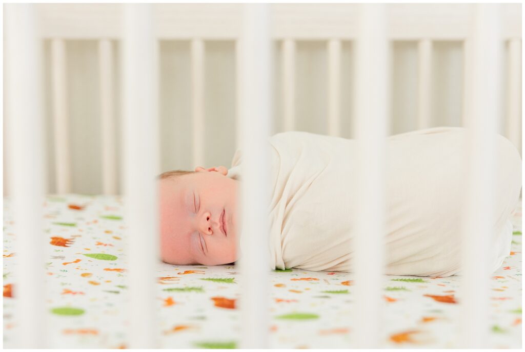 Baby sleeps in the crib during an indoor Colorado newborn session