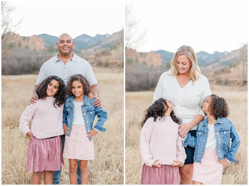Dad stands behind his two daughters and puts his hands on their shoulders