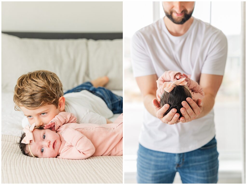 Father holds out his baby girl in his forearms while taking newborn pictures inside their Colorado home with Catherine Chamberlain Photography