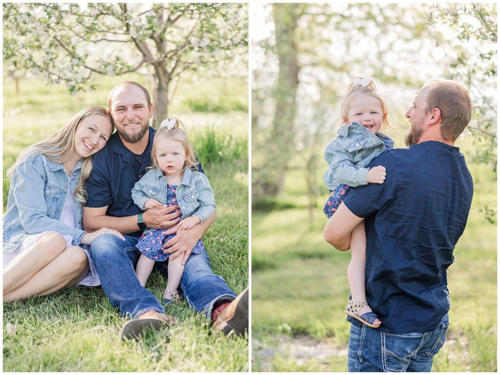 Dad's back is to the camera as his baby girl looks right at the camera and smiles during spring mini session