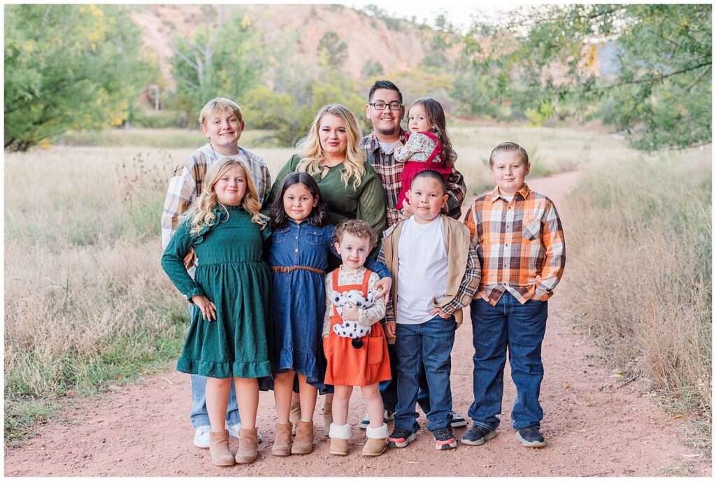 Riley Family posing for outdoor photos 
In beautiful Colorado Springs charm