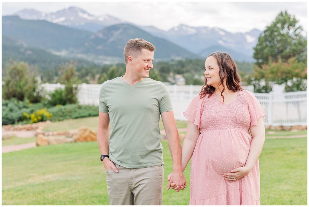 Couple hold hands during a maternity session at Estes Park, CO