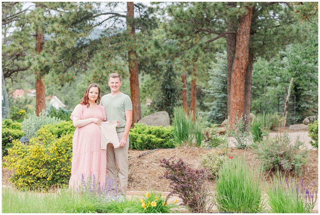 Couple expecting a baby pose for light and airy outdoor photos