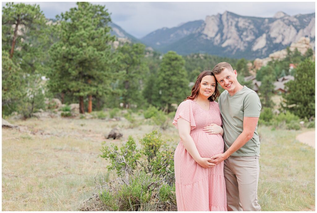 Expecting couple pose for a Stanley Hotel Maternity Session with Catherine Chamberlain