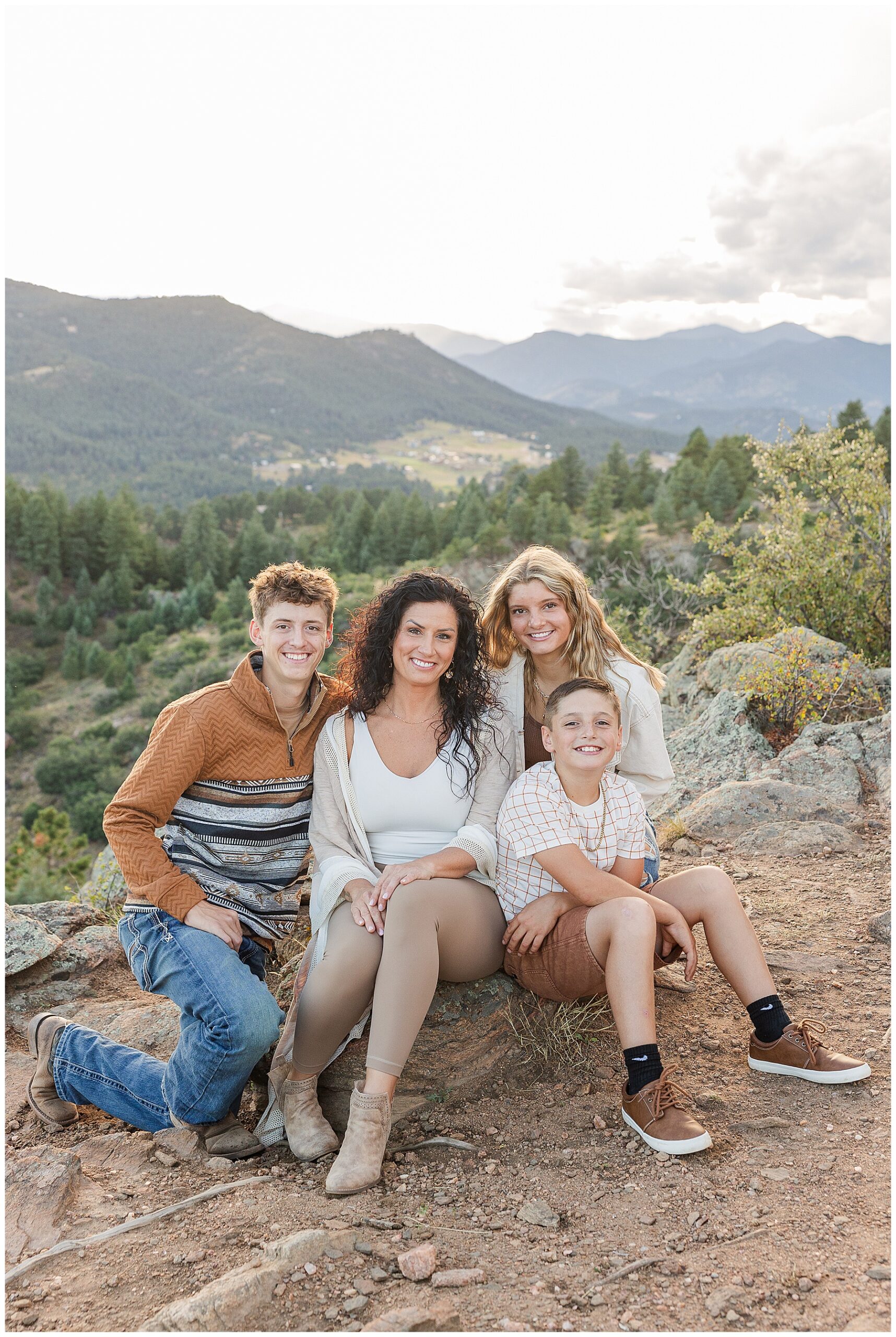 Family of four pose sitting down and are featured in a blog on the Booking Your Family Session