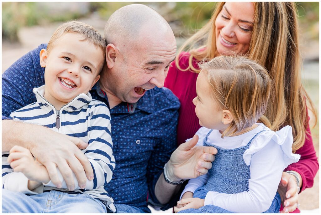 Family of four pose for photos at Buckingham Park in Boulder, CO with Catherine Chamberlain Photography