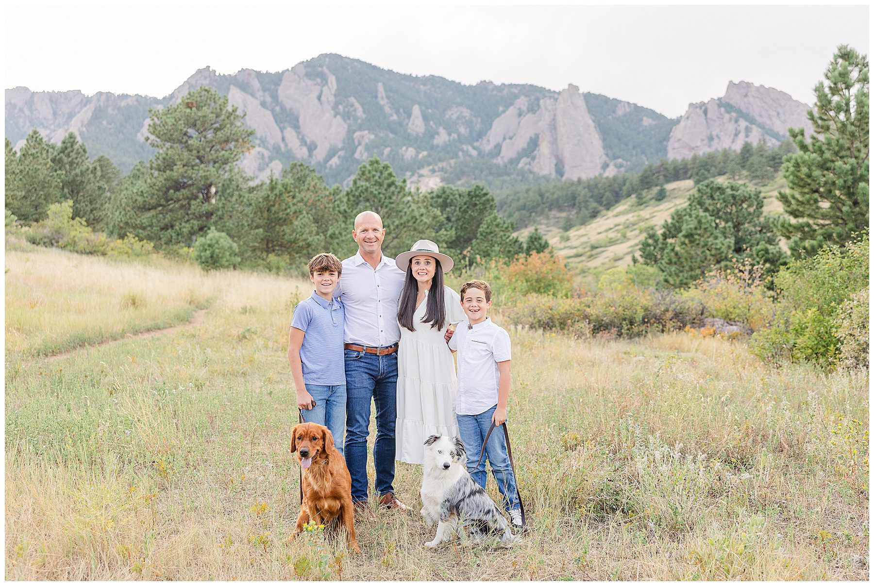 family of four pose for a blog about tips for including pet in family portraits