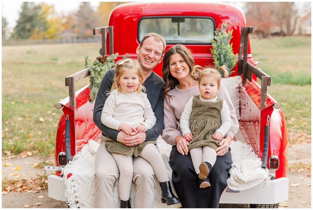 Family of four pose for festive moments in Louisville with Catherine Chamberlain Photography