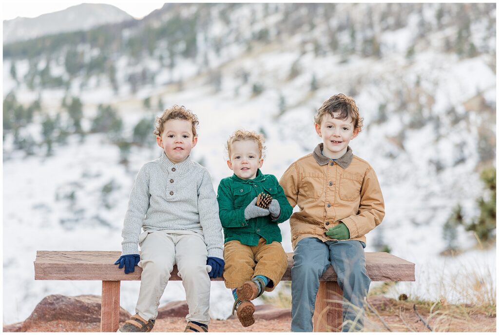 Boy pose in front of a snowy mountain in Boulder, CO and Tips for Winter Sessions
