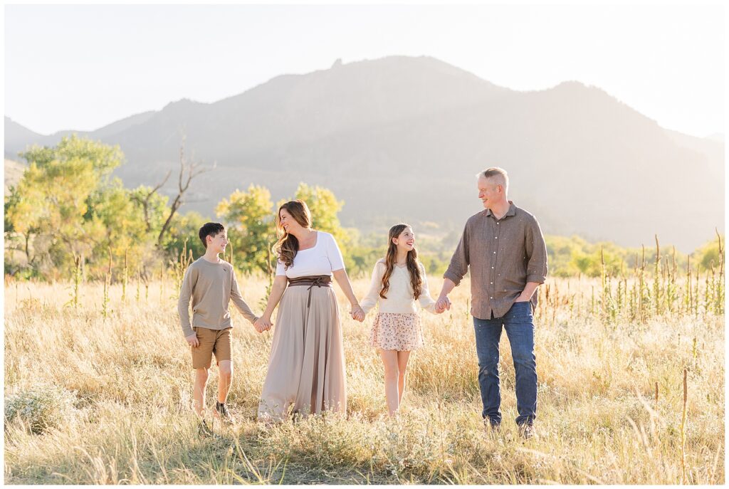 Candid photo of family holding hands with a mountain background