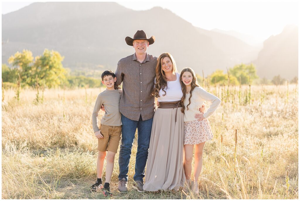 Family of four pose for light and airy outdoor photos with mountains by Catherine Chamberlain Photography