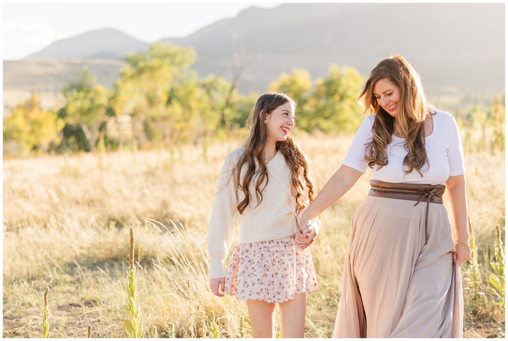 Mom and daughter take the perfect light and airy photo outside with mountains