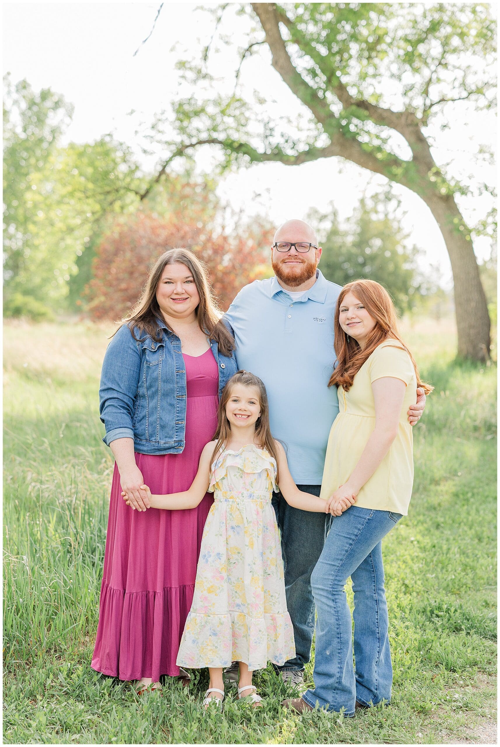 Family of four pose outside with light and airy family photographer Catherine Chamberlain of Catherine Chamberlain Photography